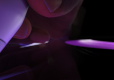 Käyttäjä pitää Apple Pencil Prota kirjoitusasennossa. Kärki painuu näytölle, jolle piirtyy paksuja kirkkaanvioletteja vetoja.